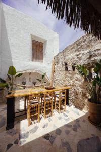 a wooden table and chairs on a patio at Casa Moro in Episkopi 16km from Rethymno in episkopi-chania
