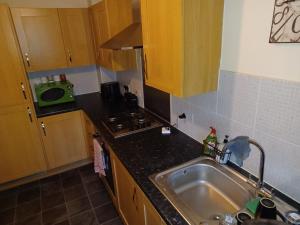 a kitchen with a sink and a stove at The Rosewood in Grays Thurrock +157 photos