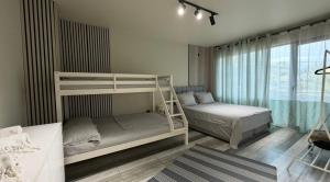 a bedroom with two bunk beds and a window at Sunmore in Kobuleti