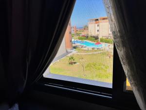 a view of a pool from a window at Helnan portfouad chalet in Chantier Island