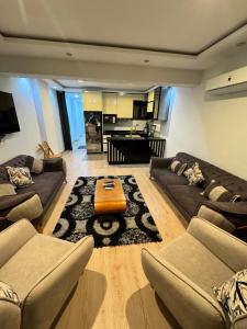 a large living room with couches and a table at Helnan portfouad chalet in Chantier Island
