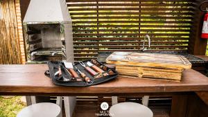 a tray of cooking utensils sitting on a table at Ibiraquera Life in Praia do Rosa
