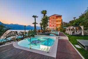a swimming pool with a view of the water at Belfiore Park Hotel 4Stars Superior "Adults Only" in Brenzone sul Garda