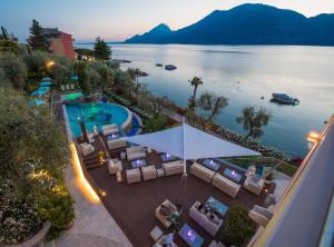 an overhead view of a resort with a pool and chairs at Belfiore Park Hotel 4Stars Superior "Adults Only" in Brenzone sul Garda