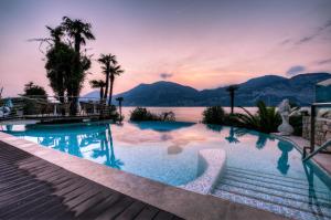 a swimming pool with a view of the water and mountains at Belfiore Park Hotel 4Stars Superior "Adults Only" in Brenzone sul Garda +92 photos
