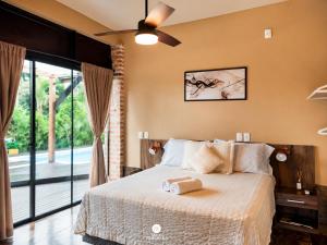 a bedroom with a bed and a sliding glass door at Ibiraquera Life in Praia do Rosa
