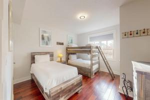 a bedroom with two bunk beds and a window at Rivergrass by Property Valet in Blue Mountains +84 photos