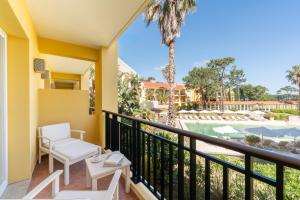 a balcony with chairs and a view of the pool at Locanda Punta Del Este in Punta del Este