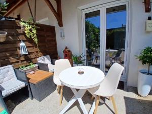 a patio with a white table and chairs at L'Escale Orléans Chambres d'hôtes in Orléans