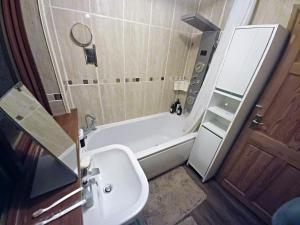 a bathroom with a tub and a sink and a toilet at The Rose in Grays Thurrock +71 photos
