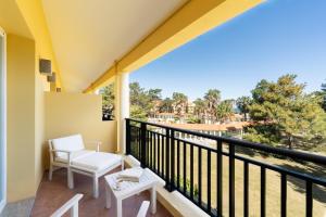 a balcony with two chairs and a view of the water at Locanda Punta Del Este in Punta del Este