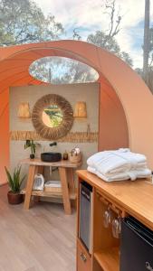 a room with a table and a mirror at Sora Bubble in Angelina