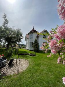a house with a bird sitting in the grass at Villa Tornhaga in Oskarström