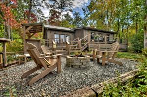a backyard patio with chairs and a cabin at Blueberry Hill Fire Pit MTN Views Grill in McCaysville