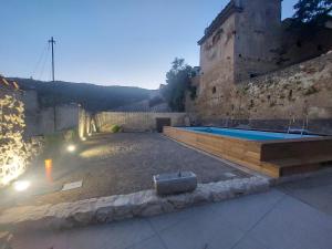 a swimming pool in front of a building at Dimora al Colle in Caporciano