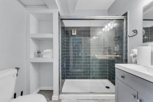 a bathroom with a shower with a glass door at Stay with Jay - Quinta Suite in Cleveland +13 photos