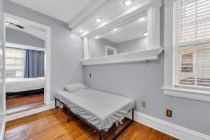 a white room with a bed and a window at Stay with Jay - Quinta Suite in Cleveland