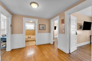 an empty room with two doors and a television at Stay with Jay - Quinta Suite in Cleveland