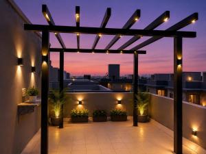 a rooftop patio with a pergola at night at sea stay inn in Mahabalipuram