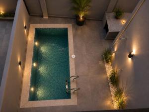 an overhead view of a swimming pool with lights at sea stay inn in Mahabalipuram