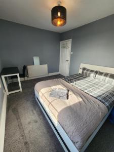 a bedroom with a large bed and a desk at The Iris in Grays Thurrock