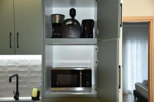 a kitchen with a microwave oven in a kitchen at Luxury Green Apartment in Serres