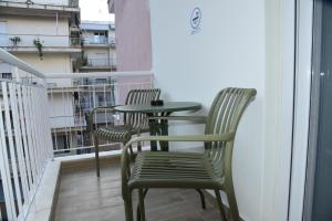 a table and two chairs on a balcony at Luxury Green Apartment in Serres