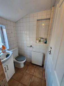 a bathroom with a toilet and a sink at The Iris in Grays Thurrock +79 photos