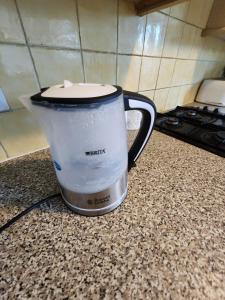 a coffee pot sitting on a counter in a kitchen at The Iris in Grays Thurrock