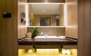 a bathroom with a sink and a mirror at Atour Hotel Hefei Hitech Avenue in Hefei