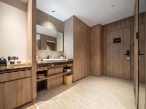 a bathroom with a sink and a mirror at Atour Hotel Hefei Hitech Avenue in Hefei