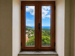 a window in a room with a view at Ana & Angelo Stone House Vuno Himarë in Vuno