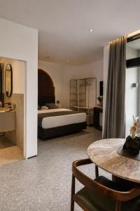 a large bedroom with a bed and a table at Valverda - Boutique Apartments in Grödig