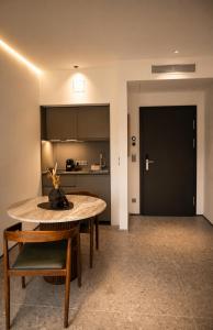 a living room with a table and a kitchen at Valverda - Boutique Apartments in Grödig