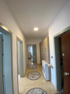 a hallway with two rugs on the floor of a house at Iljon Apartments in Tushemisht