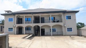 a large white house with a large courtyard at Solace Guest house in Buea