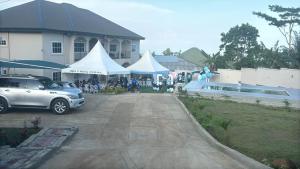 a group of tents in front of a building at Solace Guest house in Buea