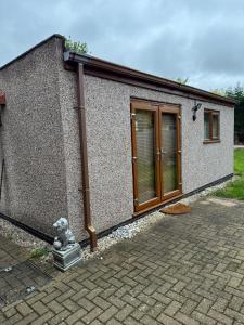 a small house with a stone facade with a door at Self contained Coventry in Coventry