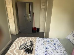 a bedroom with a bed with a zebra blanket on it at Self contained Coventry in Coventry