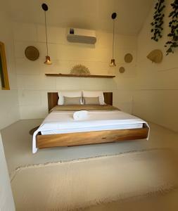 a bedroom with a bed in a small room at Villa Dolce Mare in Arraial do Cabo +203 photos