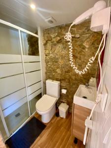 a bathroom with a toilet and a sink at Casa do Avô Grande in Esposende +48 photos