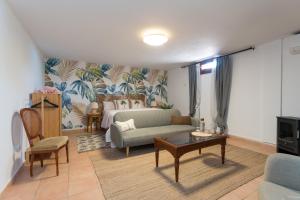 a living room with a bed and a couch at Villa Mogaren in Vega de San Mateo +90 photos