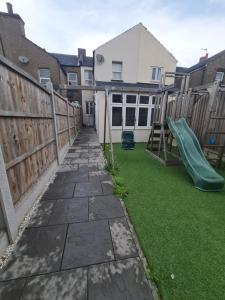 a backyard with a slide and a playground at The Carnation in Grays Thurrock