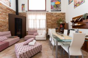a living room with a couch and a table and chairs at Villa Mogaren in Vega de San Mateo