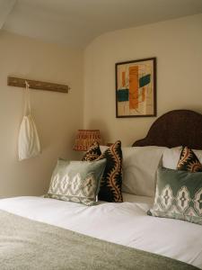 a bedroom with two beds with pillows and a couch at The Great Decoy in Hurstbourne Tarrant