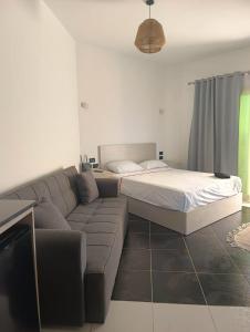 a living room with a couch and a bed at Royal Beach Resort in Hurghada +11 photos