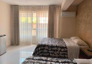 a hotel room with a bed and a window at Hotel Sky - Tarija in Tarija