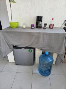 a table with a table cloth on it with a blue container under it at Casa Azul in Chicxulub