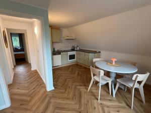 a kitchen with a table with a candle on it at Wiesenhuus in Sankt Peter-Ording