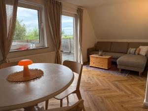 a living room with a table and a couch at Wiesenhuus in Sankt Peter-Ording